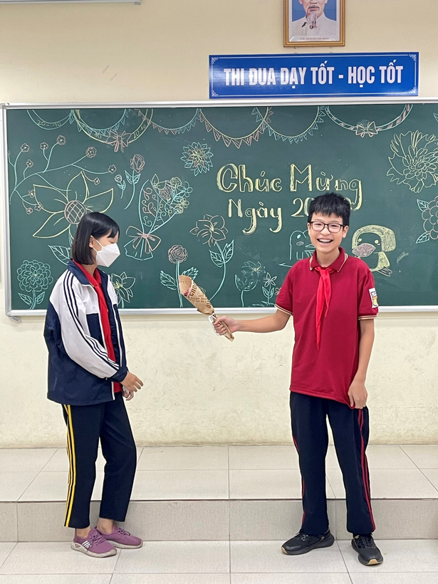 A child and child standing in front of a chalkboardDescription automatically generated with medium confidence