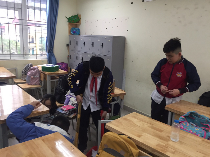 A group of boys in a classroomDescription automatically generated with low confidence