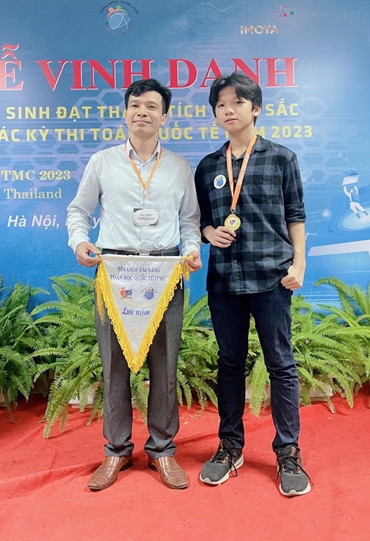 Two men standing on a red carpetDescription automatically generated with medium confidence