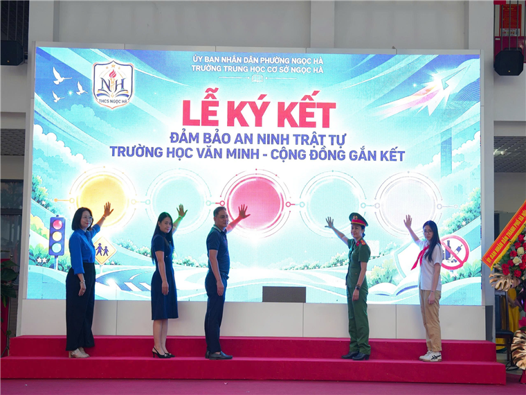 A group of people standing on a stage

Description automatically generated